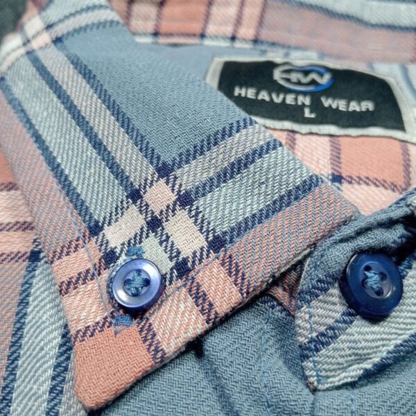 Close-up of the collar on a men's full-sleeve checked shirt, featuring pastel blue and peach tones with button detailing and a classic design.